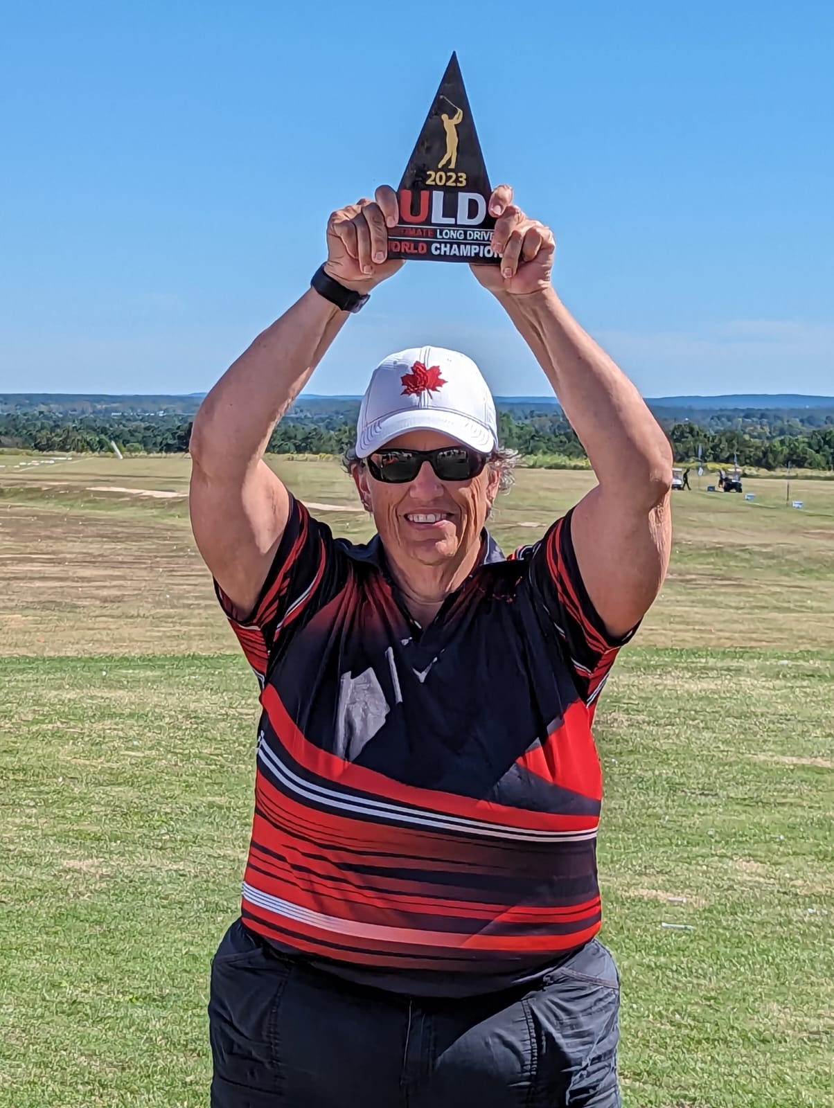 Lori Danecke holding the 2023 ULD Ultimate Long Drive World Champion trophy